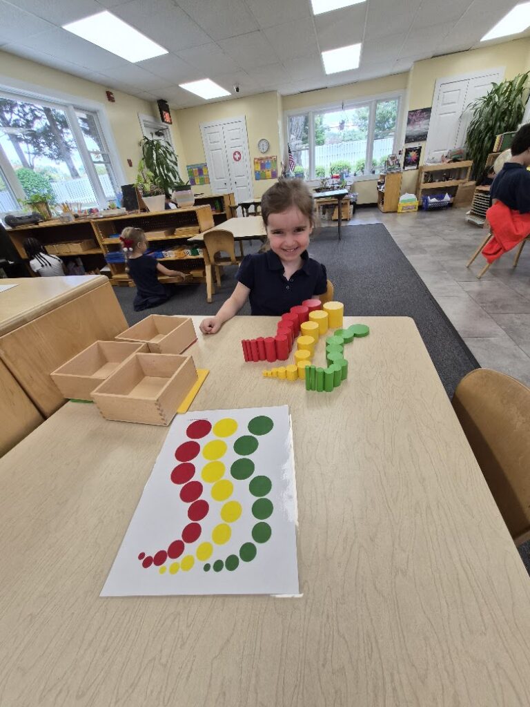 Smiling Primary student doing table work